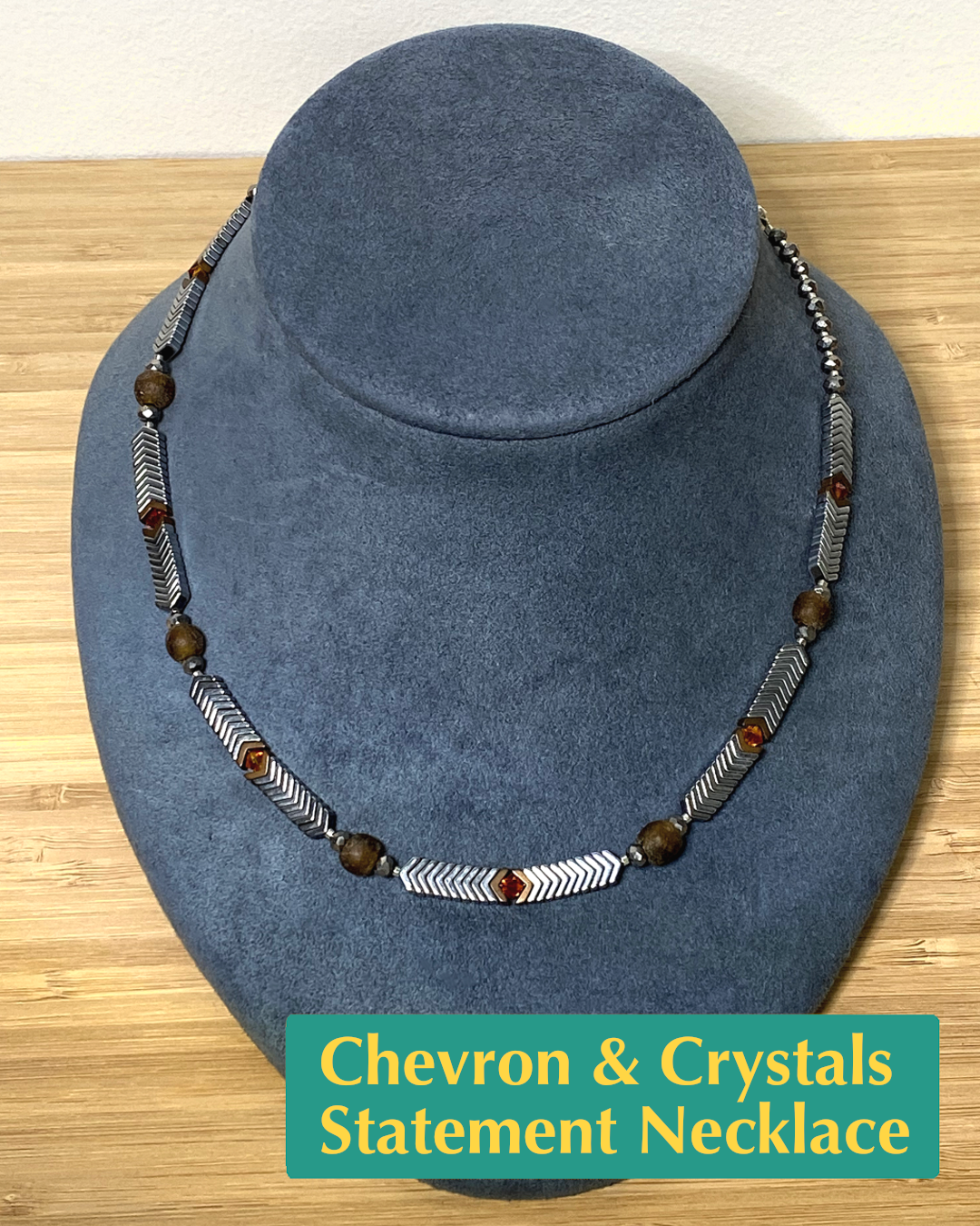 Handmade necklace with white metal and brown recycled glass, red and gray crystals, and brown and silver hematite beads