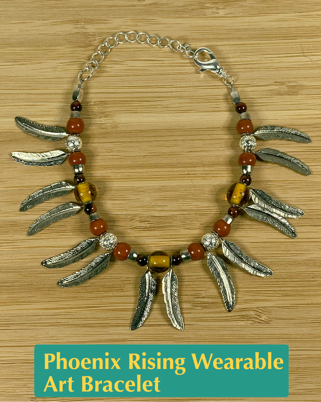 Handmade, wearable art fringe bracelet made of silver feather charms and burgundy, pink, yellow, and silver beads