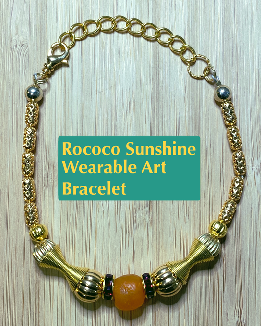 Handmade wearable art gold colored bracelet with gold, orange, and red focal beads