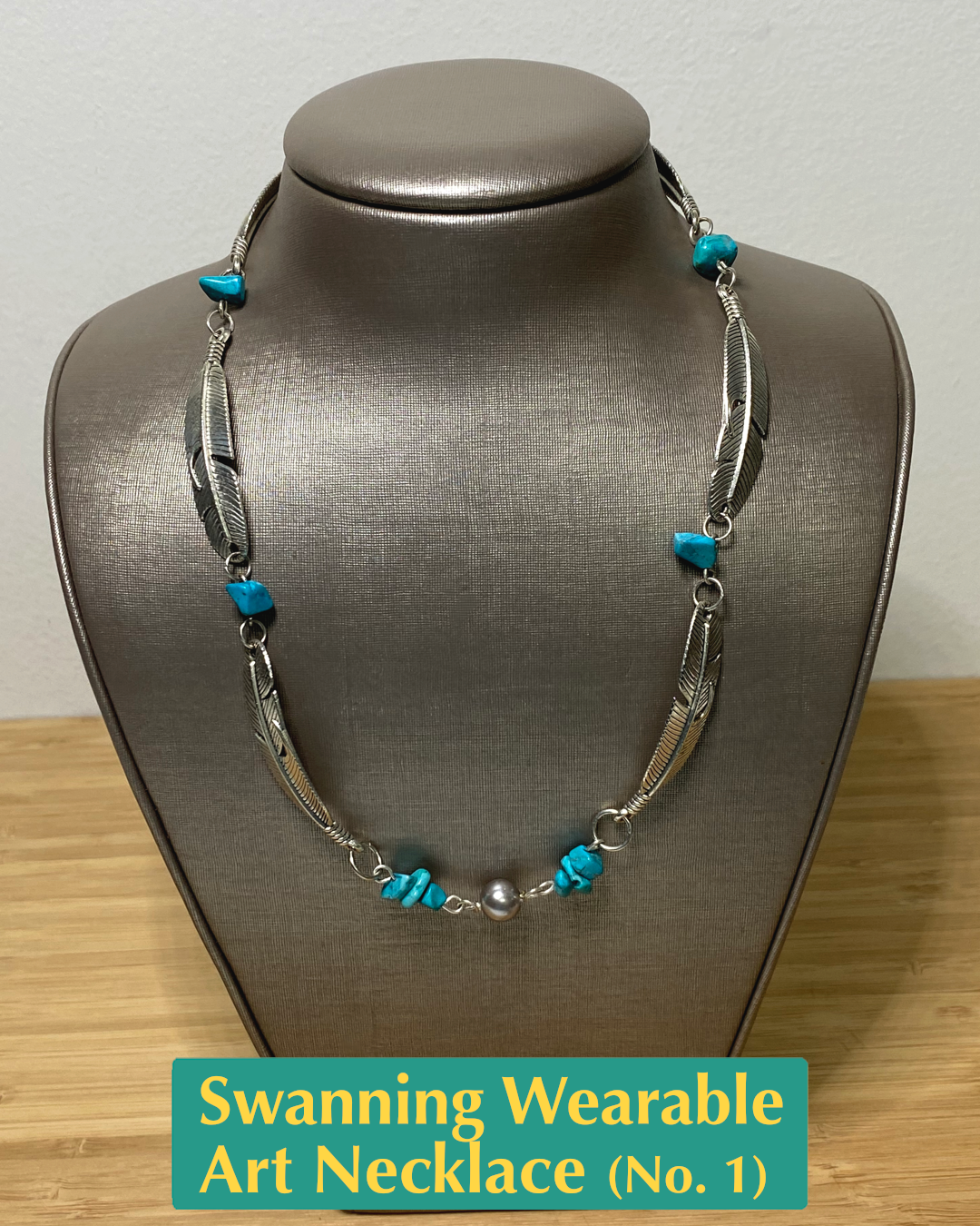 Handmade, wearable art swanning necklace on display